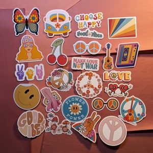 May include: A collection of colorful, retro-style stickers with a 1960s and 1970s theme. Designs include a butterfly, a VW bus, peace signs, a smiley face, a guitar, and the phrases "Choose Happy," "Good Vibes," and "Make Love Not War."