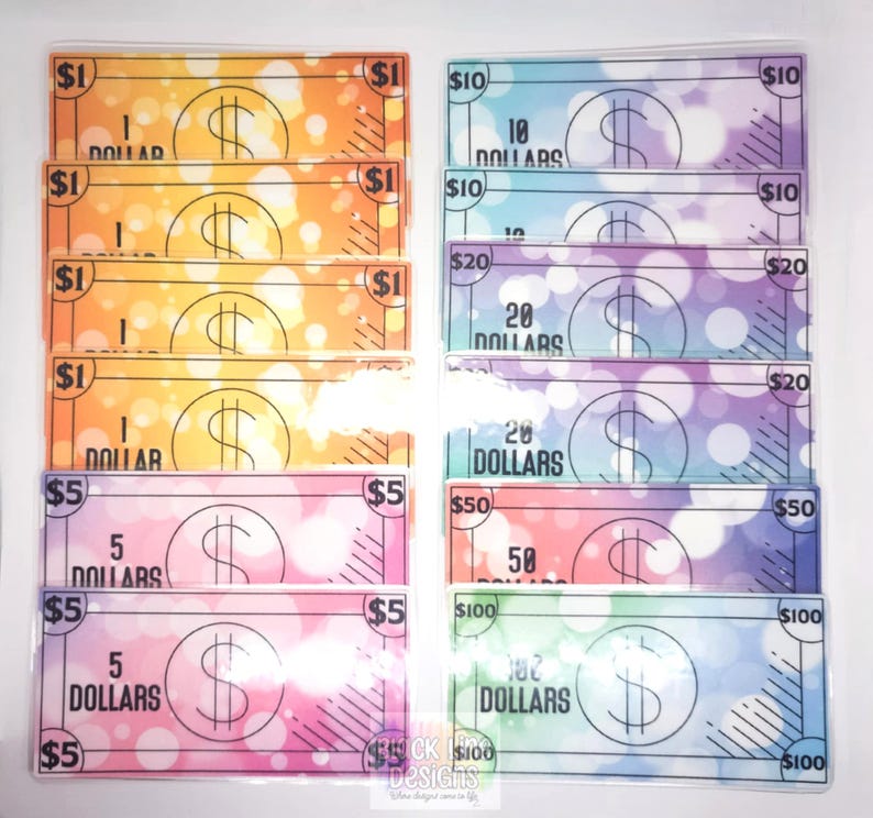May include: A set of colorful play money bills with different denominations, including $1, $5, $10, $20, $50, and $100. The bills have a watercolor background with a dollar sign and the amount written on each bill.