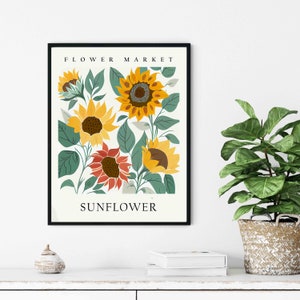 May include: A printable art print featuring a vintage botanical illustration of sunflowers. The print has a white background with green leaves and yellow sunflowers. The text "FLOWER MARKET" and "SUNFLOWER" is printed in black at the top and bottom of the print.