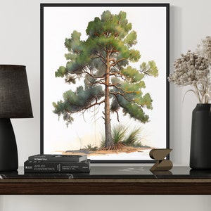 May include: A black framed print of a watercolor painting of a pine tree on a white background. The print is hanging on a white wall above a black marble topped console table. A black lamp with a gray fabric shade sits on the table, along with a black vase filled with dried flowers and a small wooden sculpture.