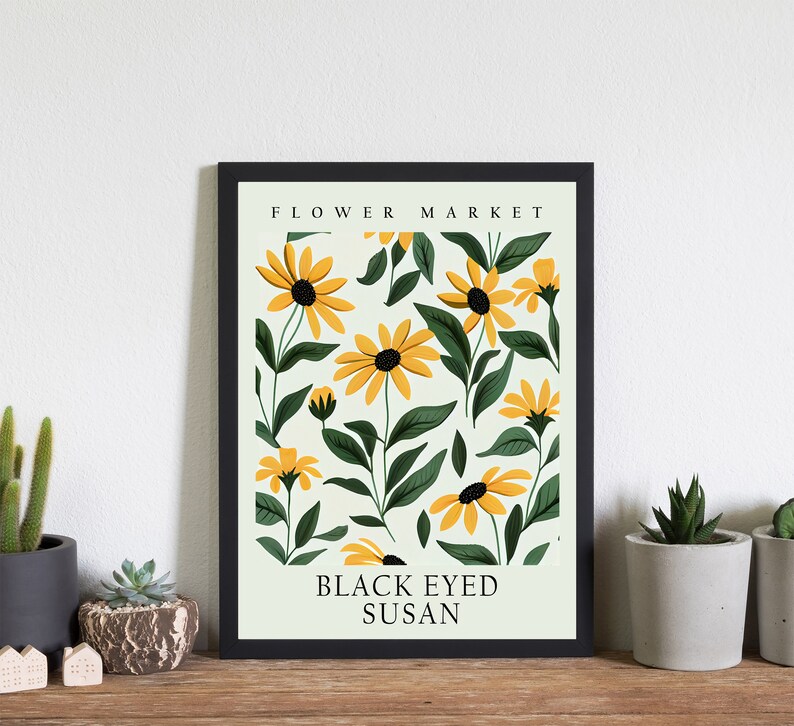 May include: A black framed print with a white background and a pattern of yellow and green flowers. The text "FLOWER MARKET" and "BLACK EYED SUSAN" is printed in black.