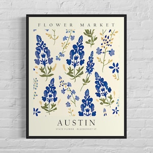 May include: A cream-colored poster with a black frame featuring a floral pattern of bluebonnets, the state flower of Texas, with the text "FLOWER MARKET" at the top and "AUSTIN" at the bottom with the text "STATE FLOWER - BLUEBONNET SP."