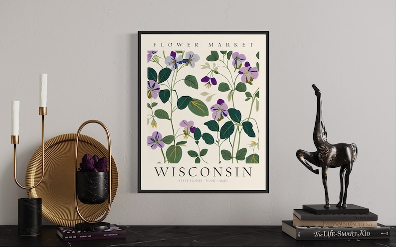 May include: A botanical print poster with a white background and a black frame. The poster features a floral design of purple and green wood violets, the state flower of Wisconsin. The text "FLOWER MARKET" and "WISCONSIN STATE FLOWER WOOD VIOLET" is printed on the poster.