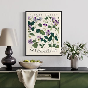 May include: A framed botanical print featuring purple and green flowers with the text "FLOWER MARKET WISCONSIN STATE FLOWER: WOOD SORREL"