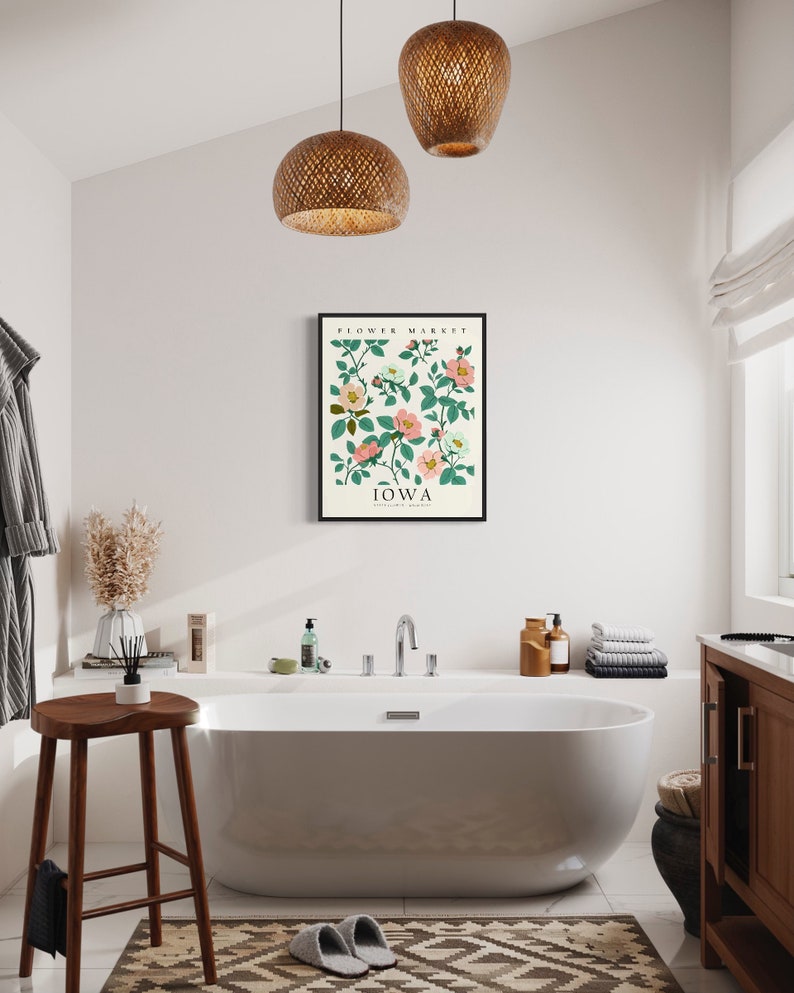 May include: A white bathtub with a white towel on the side, a wooden stool, and a framed print of a floral design with the text "Flower Market, Iowa" on a white background.