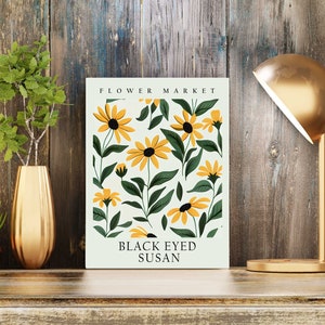 May include: A light green card with a floral pattern of black-eyed susans. The text "FLOWER MARKET" is at the top and "BLACK EYED SUSAN" is at the bottom.