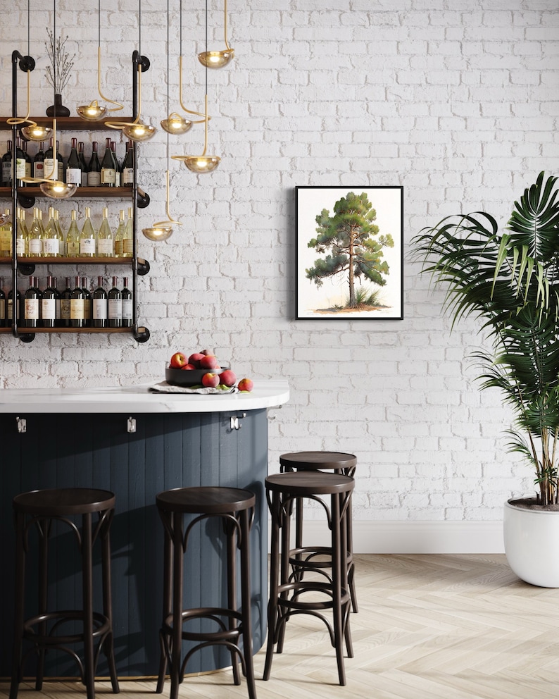 May include: A white brick wall with a framed watercolor painting of a pine tree. A dark blue bar counter with four black bar stools. A potted plant with green leaves is on the right side of the image.