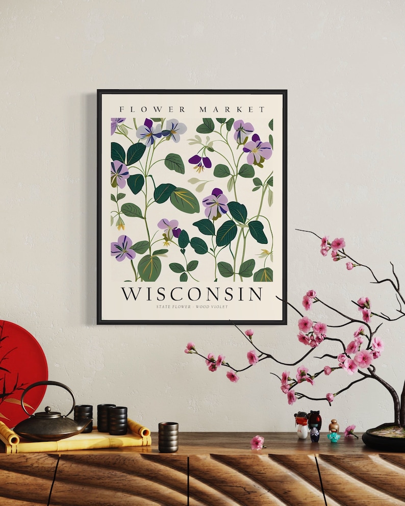 May include: A framed print with a floral design featuring purple flowers and green leaves. The print has the text "FLOWER MARKET" at the top and "WISCONSIN STATE FLOWER - WOOD VIOLET" at the bottom.