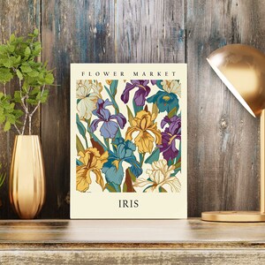 May include: A vintage-style poster featuring a floral illustration of irises in shades of purple, yellow, and blue. The poster has the text "FLOWER MARKET" at the top and "IRIS" at the bottom.