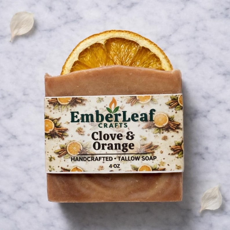 Tallow bar soap bundle by EmberLeaf Crafts. The image shows a variety of colorful, natural soaps—Rose Flower, Citrus Grove, and Oak & Elderberry—neatly laid out on a clean marble surface with scattered white flower petals.