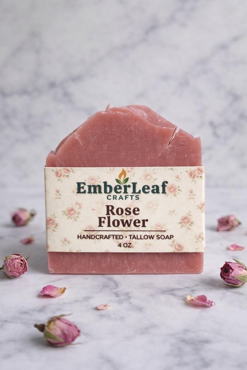 Tallow bar soap bundle by EmberLeaf Crafts. The image shows a variety of colorful, natural soaps—Rose Flower, Citrus Grove, and Oak & Elderberry—neatly laid out on a clean marble surface with scattered white flower petals.