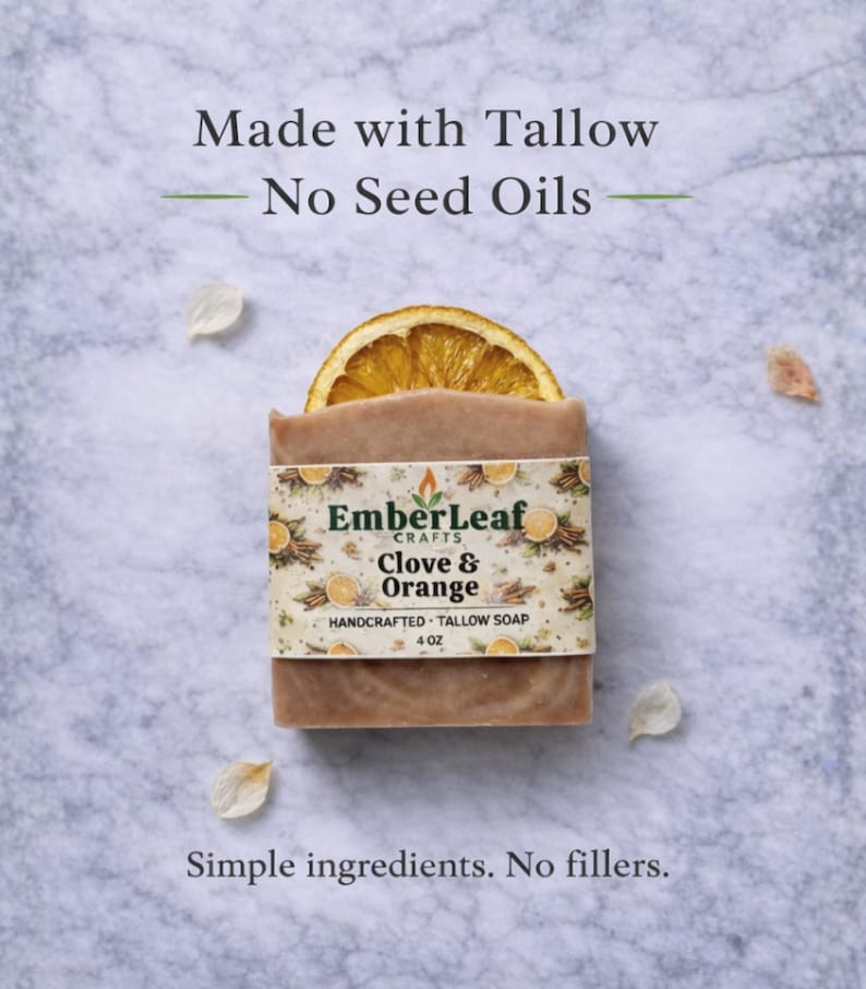 Tallow bar soap bundle by EmberLeaf Crafts. The image shows a variety of colorful, natural soaps—Rose Flower, Citrus Grove, and Oak & Elderberry—neatly laid out on a clean marble surface with scattered white flower petals.