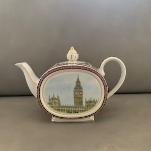 May include: White porcelain teapot with a gold trim and a painted image of Big Ben and the Houses of Parliament in London.
