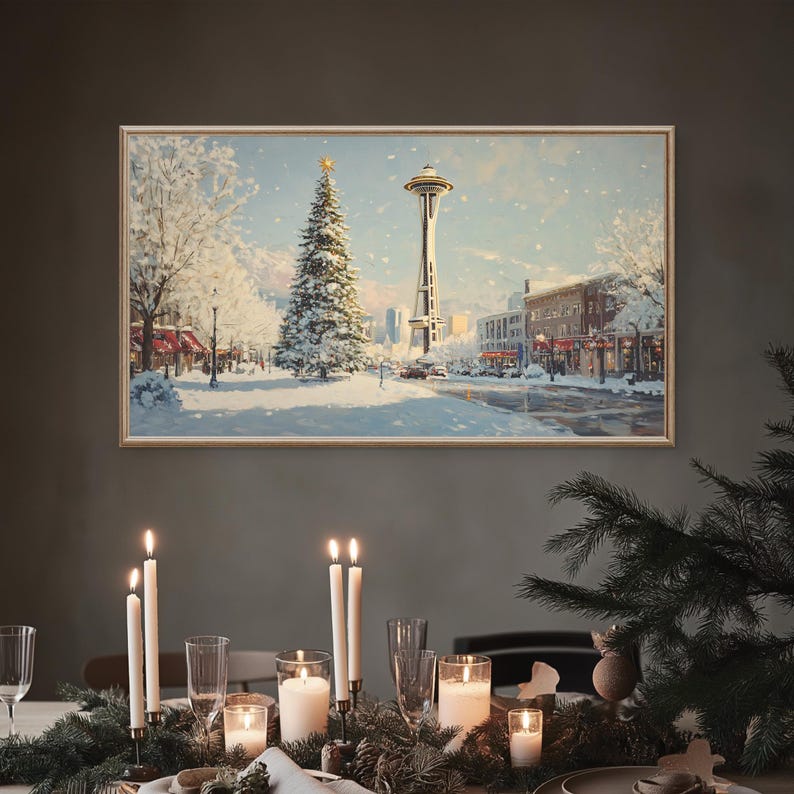 May include: A snowy winter scene with a tall Christmas tree and the Space Needle in the background. The scene is framed in a wooden frame and hung on a gray wall. A table is set with candles and greenery in the foreground.