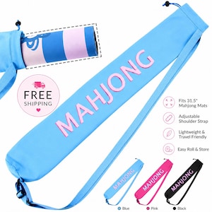 May include: A light blue cylindrical carrying case for a mahjong mat, featuring the word MAHJONG in pink lettering. The bag includes an adjustable shoulder strap and a drawstring closure at the top. It is designed to fit 31.5-inch mahjong mats.