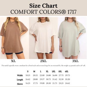 May include: Size chart for Comfort Colors 1717 t-shirts. The chart includes measurements for width, length, and sleeve length in inches for sizes S through 4XL. The image shows three t-shirts in different colors: brown, white, and green.