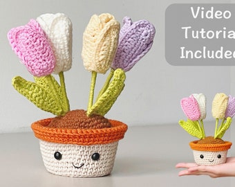 May include: A crocheted flower pot with a smiling face and five colorful tulips. The pot is orange and white with brown soil. The tulips are pink, white, yellow, and purple. The image includes the text "Video Tutorial Included".