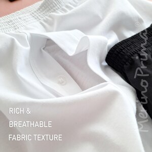 May include: Close-up of a white fabric with a button and the text "RICH & BREATHABLE FABRIC TEXTURE".