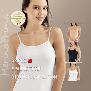 May include: A set of three white spaghetti tops made of 100% natural cotton. The tops are shown on a model and are available in cream, black, and white.