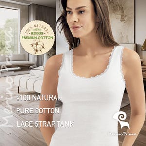 May include: White lace-trimmed tank top made of 100% natural pure cotton. The tank top has a scoop neck and is sleeveless. The text "100% NATURAL PURE COTTON LACE STRAP TANK" is printed on the front of the tank top.
