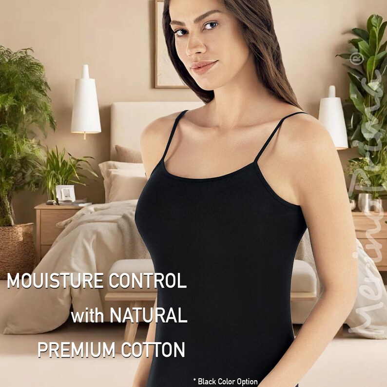 May include: A black tank top made of premium cotton with moisture control. The tank top has thin straps and a scoop neck. The text "Moisture Control with Natural Premium Cotton" is displayed on the image.