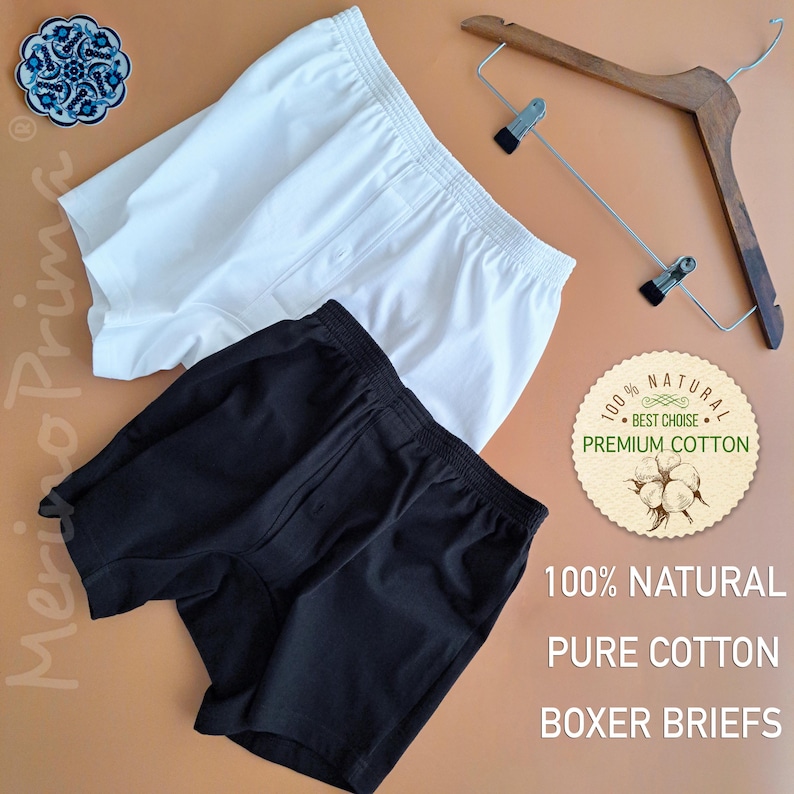 May include: Two pairs of boxer briefs, one white and one black, made of 100% natural premium cotton. The text on the label reads "100% NATURAL BEST CHOICE PREMIUM COTTON 100% NATURAL PURE COTTON BOXER BRIEFS".