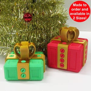 May include: Two decorative gift boxes, one red and one green, with gold ribbon and accents. Made to order and available in 2 sizes.