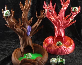 May include: Two 3D printed tree-shaped dice towers, one brown and one red, with green and white dice scattered around them.