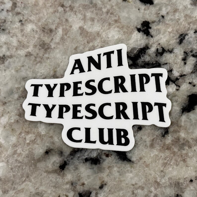 May include: White sticker with black text that reads "ANTI TYPESCRIPT TYPESCRIPT CLUB".