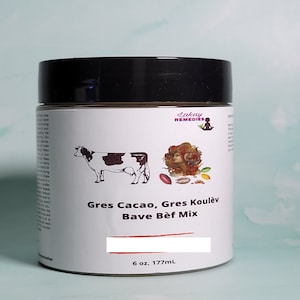 May include: A white jar with a black lid and a label that reads "Lakay Remedies". The label also features a cow, a woman with long hair, and the text "Gres Cacao, Gres Koulèv Bave Bèf Mix". The jar contains 6 ounces (177 ml) of product.