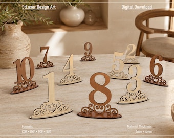May include: A set of ten laser-cut wooden table numbers from 1 to 10, each featuring a decorative scrollwork base. The text StLaser Design Art and Digital Download are visible. The material thickness is listed as 3mm and 4mm with formats CDR, DXF, PDF, SVG.