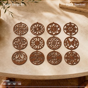 May include: Twelve circular brown wooden ornaments featuring intricate laser-cut patterns, including geometric shapes, floral motifs, and a butterfly design. Each piece has a small hole at the top for hanging. Text includes StLaser Design Art, Digital Download, and Formats CDR, DXF, PDF, SVG.