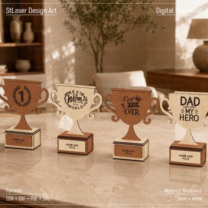 May include: Four laser-cut wooden trophy awards with rectangular bases. The first trophy features a number one inside a laurel wreath. The second reads "BEST MOM IN THE WORLD". The third says "BEST DAD EVER". The fourth reads "DAD YOU ARE MY HERO".