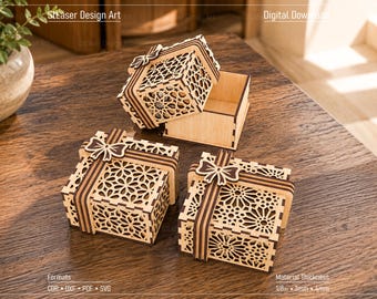 May include: Three light-colored wooden gift boxes with intricate laser-cut geometric patterns on the lids and sides. Each box features a decorative wooden bow on top. One box is open, revealing its interior. Text includes Digital Download, 1/8in, 3mm, 4mm.