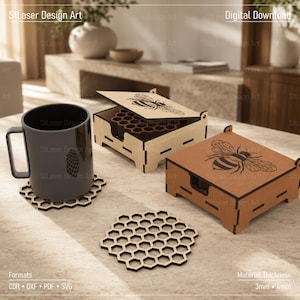 May include: A set of laser-cut wooden coasters featuring a honeycomb pattern, accompanied by two square storage boxes with bee illustrations on the lids. One box is light wood, the other is dark wood. A dark grey mug sits on one coaster.