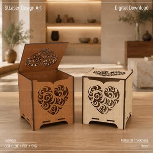 May include: Two square wooden boxes with laser-cut heart patterns on the sides and lids. One box is light brown, the other is beige. The text StLaser Design Art, Digital Download, Formats CDR, DXF, PDF, SVG, and Material Thickness 3mm is visible.