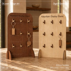 May include: Two wooden keychain display stands with arched tops, one in dark brown and one in light beige. Each stand features nine small hooks for hanging keychains and the text Keychain Display Stand engraved at the top of the front panel.