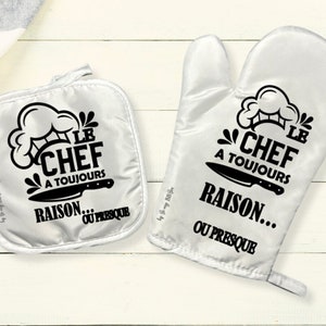 Könnte beinhalten: Weißes Ofenhandschuh- und Topflappen-Set mit schwarzem Text und Grafiken. Der Text lautet "LE CHEF A TOUJOURS RAISON... OU PRESQUE" mit einem Kochmützen- und Messer-Grafik.