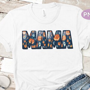 May include: White t-shirt with a blue "MAMA" graphic. The letters are filled with a pattern of orange pumpkins and ghosts.