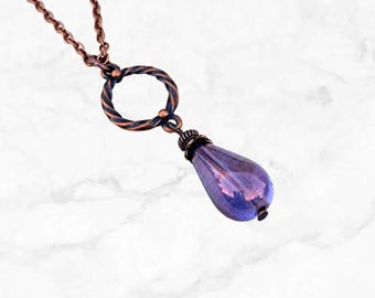 May include: A copper necklace with a twisted circle pendant and a teardrop-shaped purple glass bead.