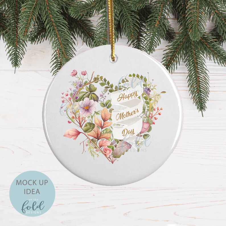 May include: White ceramic ornament with a floral heart design and the text "Happy Mother's Day" in gold lettering.