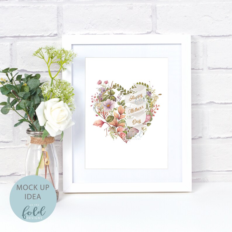 May include: White frame with a floral heart design and the text "Happy Mother's Day" in gold lettering. The heart is made of watercolor flowers and leaves.