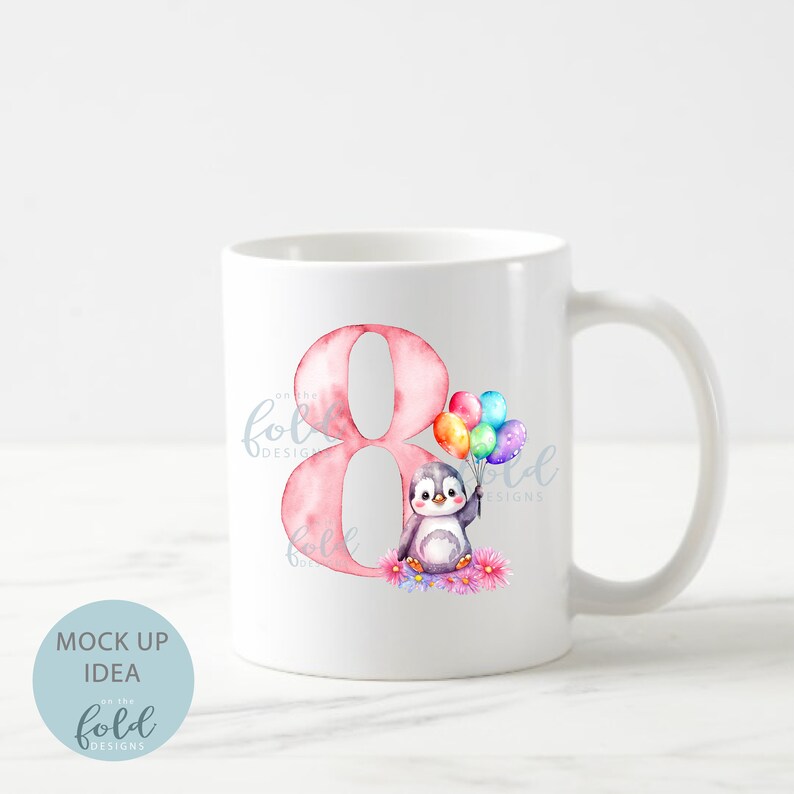 May include: White ceramic mug with a pink number eight and a cartoon penguin holding colorful balloons. The penguin is surrounded by pink flowers.