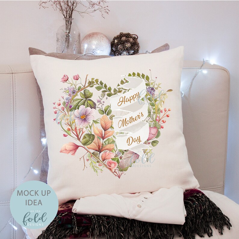 May include: White pillow with a floral heart design and a white ribbon with the text "Happy Mother's Day" in gold lettering.
