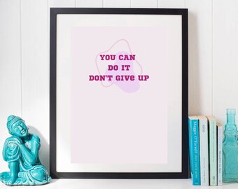 May include: A framed print with a pink background and a purple abstract shape. The text "YOU CAN DO IT DON'T GIVE UP" is written in bold, pink letters.