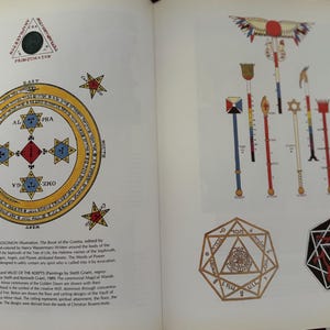 May include: Two-page spread from a book featuring illustrations of esoteric symbols and diagrams. The left page displays a circular diagram with stars and text, while the right page shows various ceremonial staffs and geometric shapes.