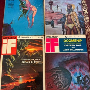 May include: Four vintage science fiction paperback books. The covers feature colorful illustrations of futuristic scenes and characters. Titles include "The Merchants of Venus," "The Wizard of Anharitte," "Doomship," and "Construction Shack."