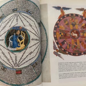 May include: Two-page spread from a book featuring medieval illustrations. One page displays a detailed circular diagram with text and geometric lines. The other page shows a colorful zodiac wheel with figures and text, with angel figures at the top.