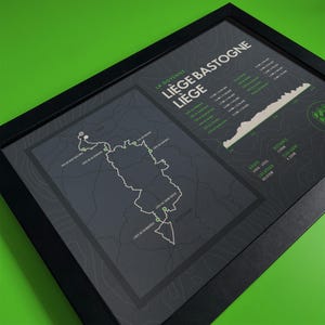 May include: A black and white map of the Liege-Bastogne-Liege cycling race route in Belgium. The map shows the route of the race, which is 254.8 km long and has 4,300 m of elevation gain. The map also includes the names of the towns and villages along the route.