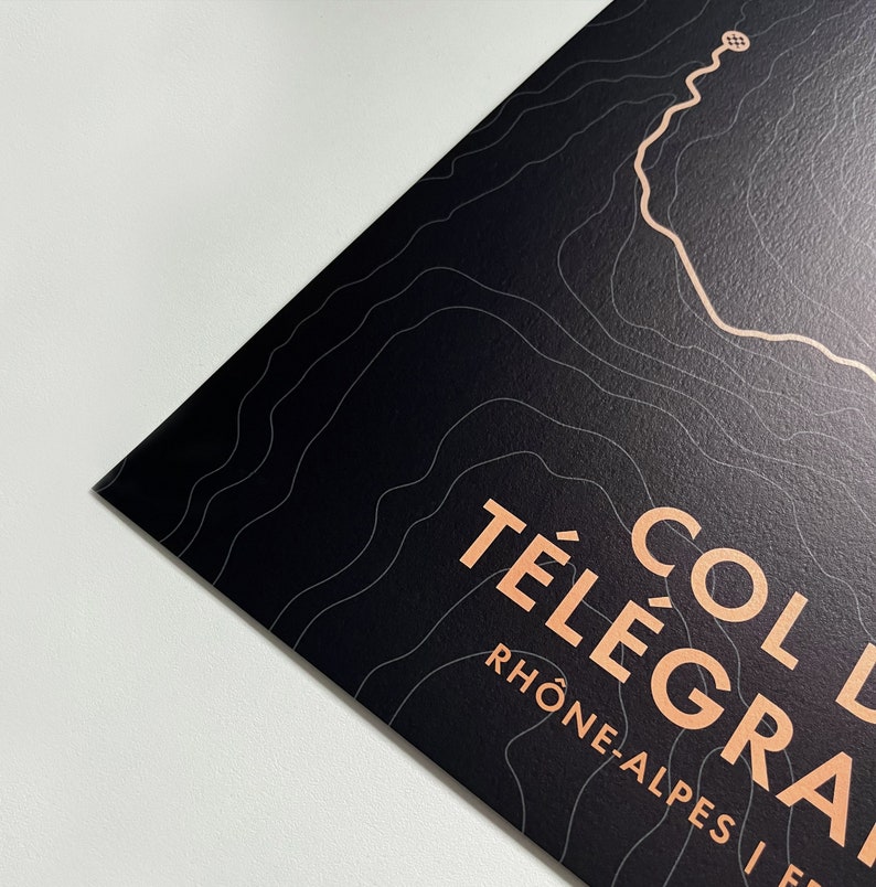 May include: A black and white topographic map print with the text "Col du T&eacute;l&eacute;graphe" and "Rh&ocirc;ne-Alpes" in a peachy-orange color.